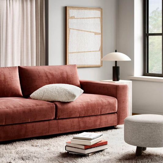 Modern living room with dusty rose velvet sofa, white minimalist art, dome lamp & shag rug