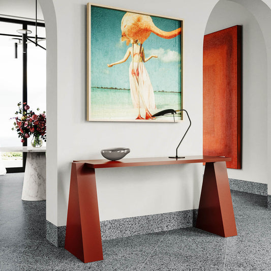 Modern entryway with red console table, surreal floating figure artwork, floral arrangement, arched walls & terrazzo floor