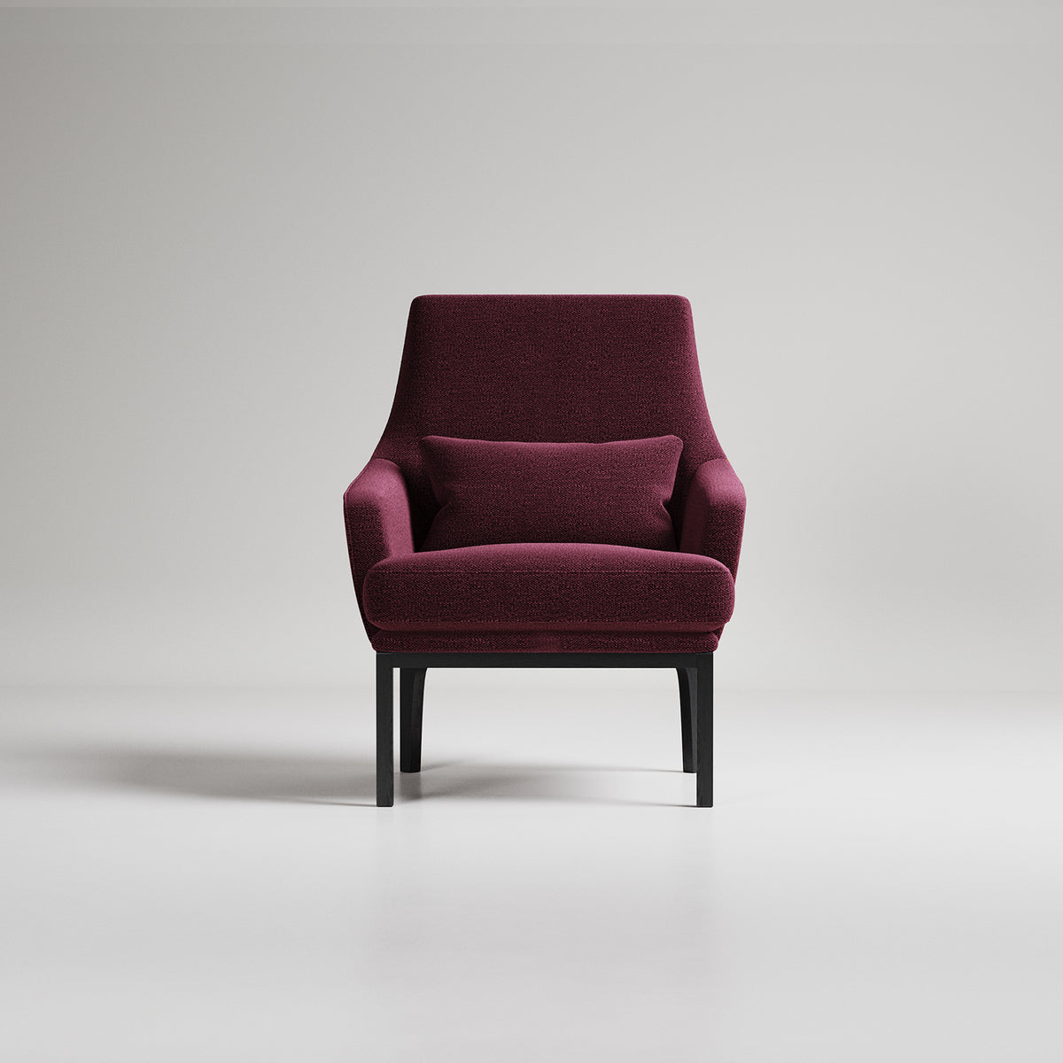 Modern burgundy armchair with black legs on light gray background, studio photography
