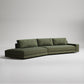 Large modern olive green sectional sofa with clean lines and chaise lounge on gray background
