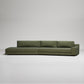 Long modern olive green sectional sofa with clean lines on white background, minimalist design
