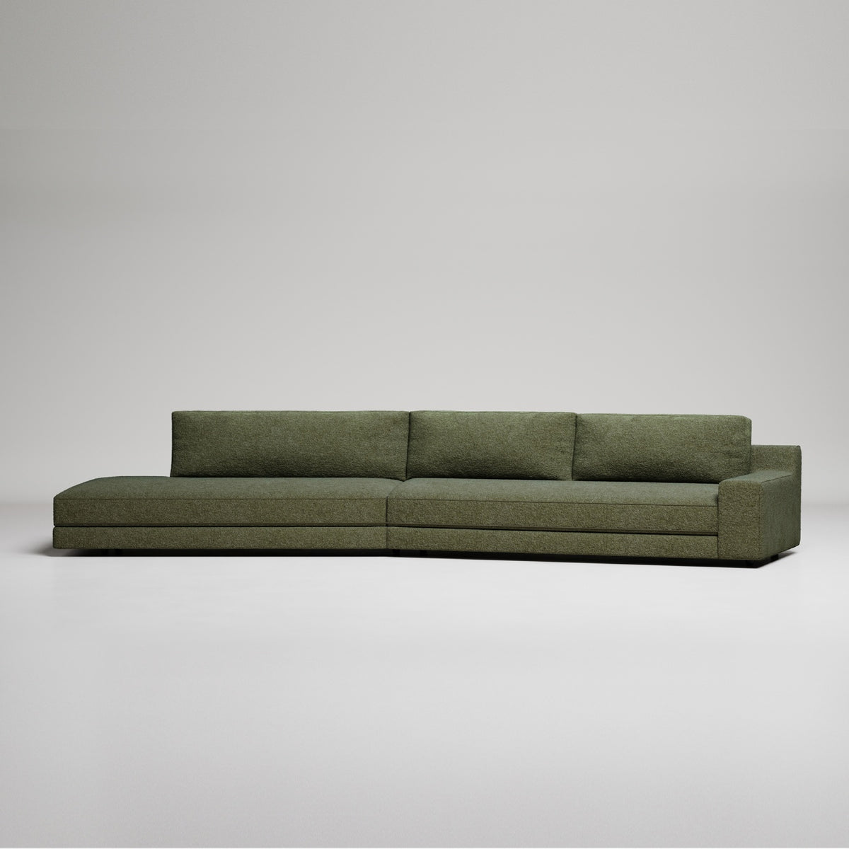 Long modern olive green sectional sofa with clean lines on white background, minimalist design
