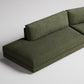 Modern olive green chaise lounge sofa section with minimalist design against white background
