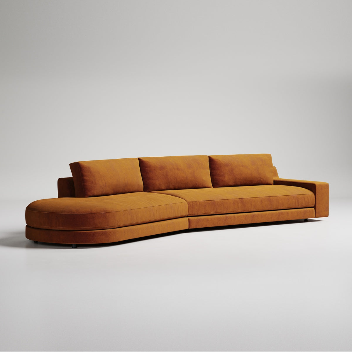 Modern curved sectional sofa in burnt orange velvet with three back cushions against light gray background
