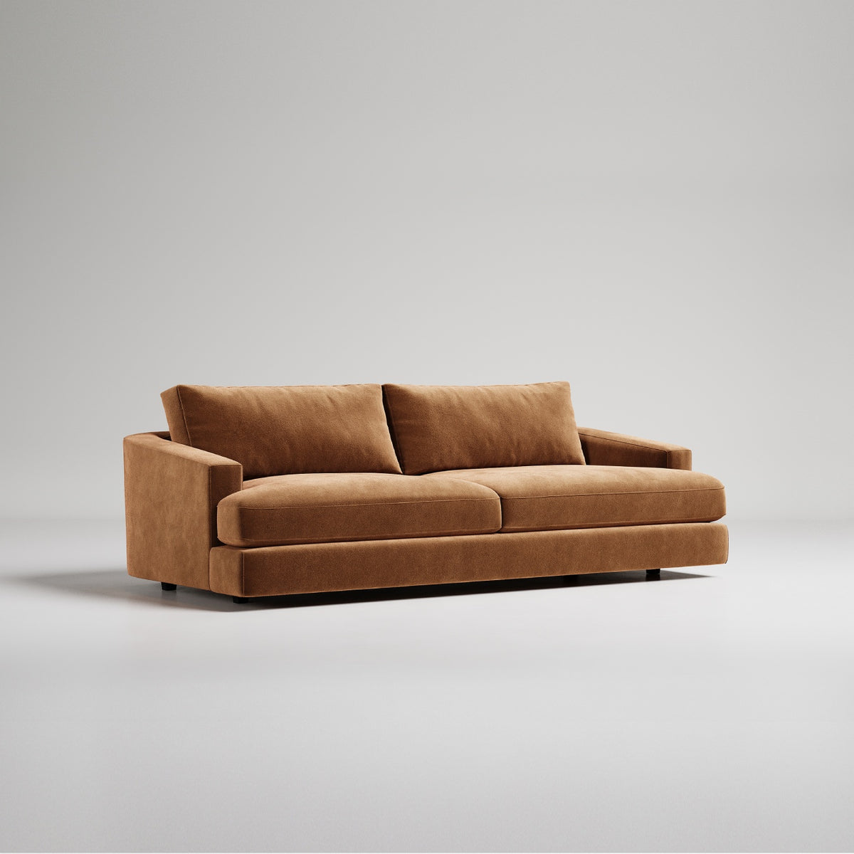 Modern brown velvet sofa with clean lines and low profile against neutral gray background
