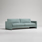 Modern mint green sofa with clean lines and wide arms on gray background, studio product photography
