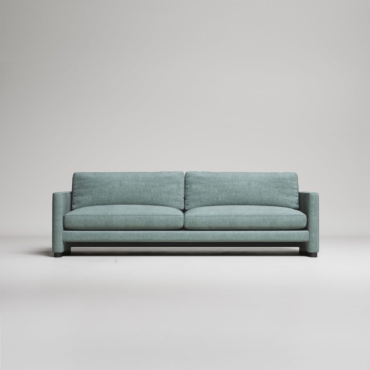 Modern sage green upholstered sofa with clean lines and square arms against neutral gray background
