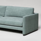 Modern mint green sofa with clean lines, dark wood base, and textured upholstery against white background
