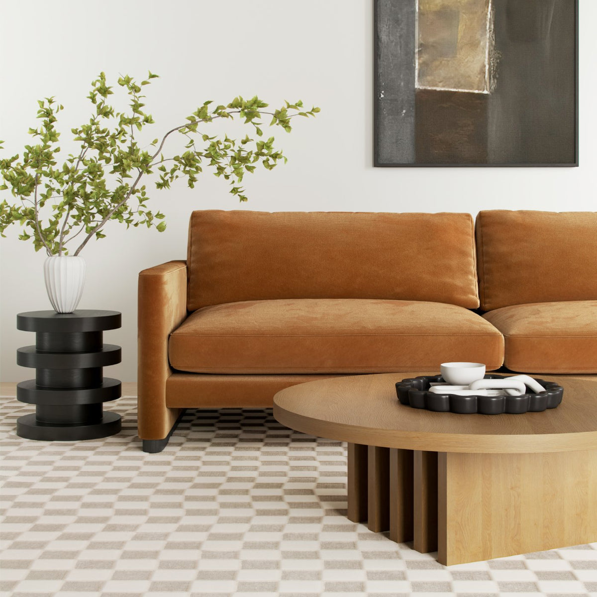 Modern living room with tan velvet sofa, geometric side tables, plant decor & patterned floor
