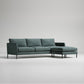 Modern L-shaped sectional sofa in forest green fabric with metal legs, photographed against white background
