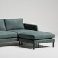 Sleek modern green sectional sofa with chaise lounge on black metal legs against white backdrop
