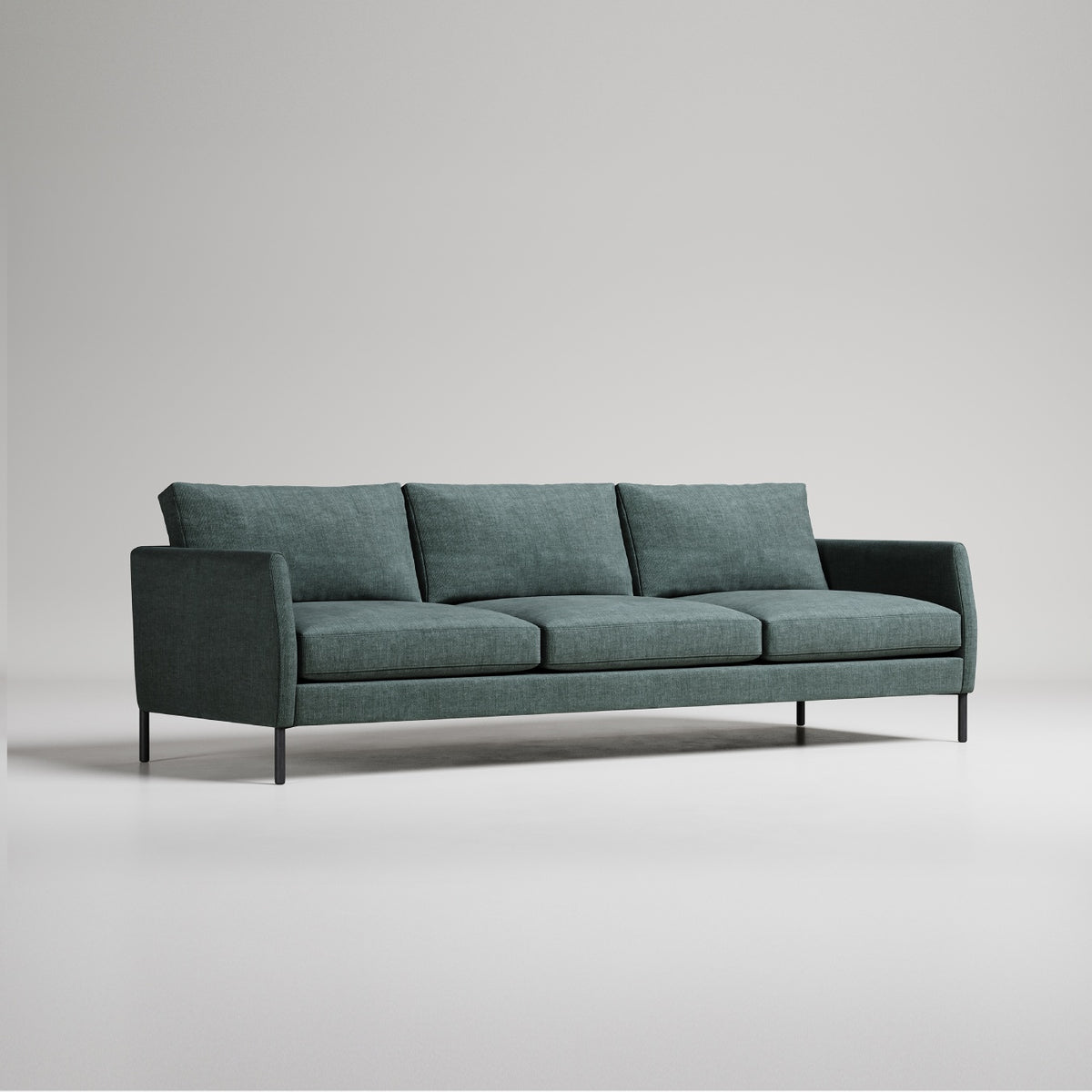 Modern green 3-seater sofa with black metal legs on light grey background, minimalist studio photo
