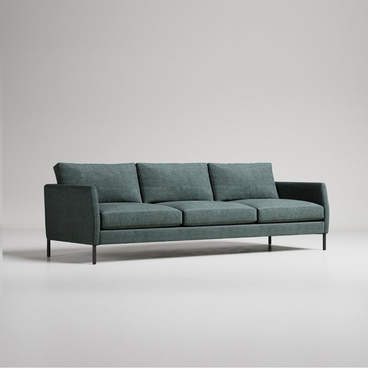 Modern green 3-seater sofa with black metal legs on light grey background, minimalist studio photo
