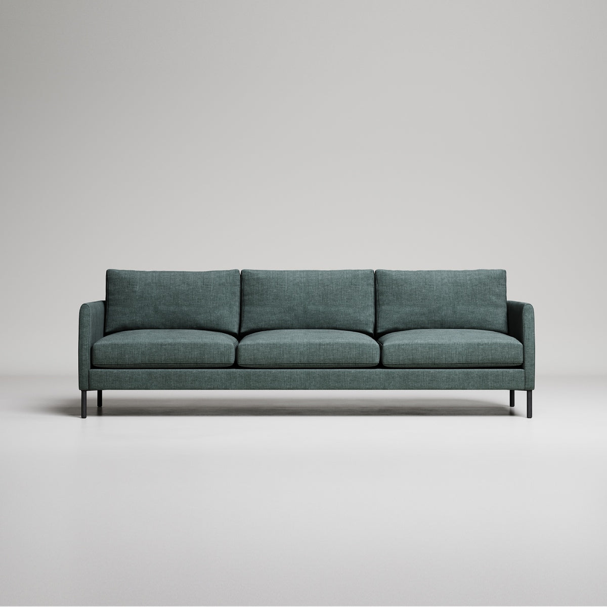 Modern green three-seater sofa with black metal legs on light gray background, studio setting
