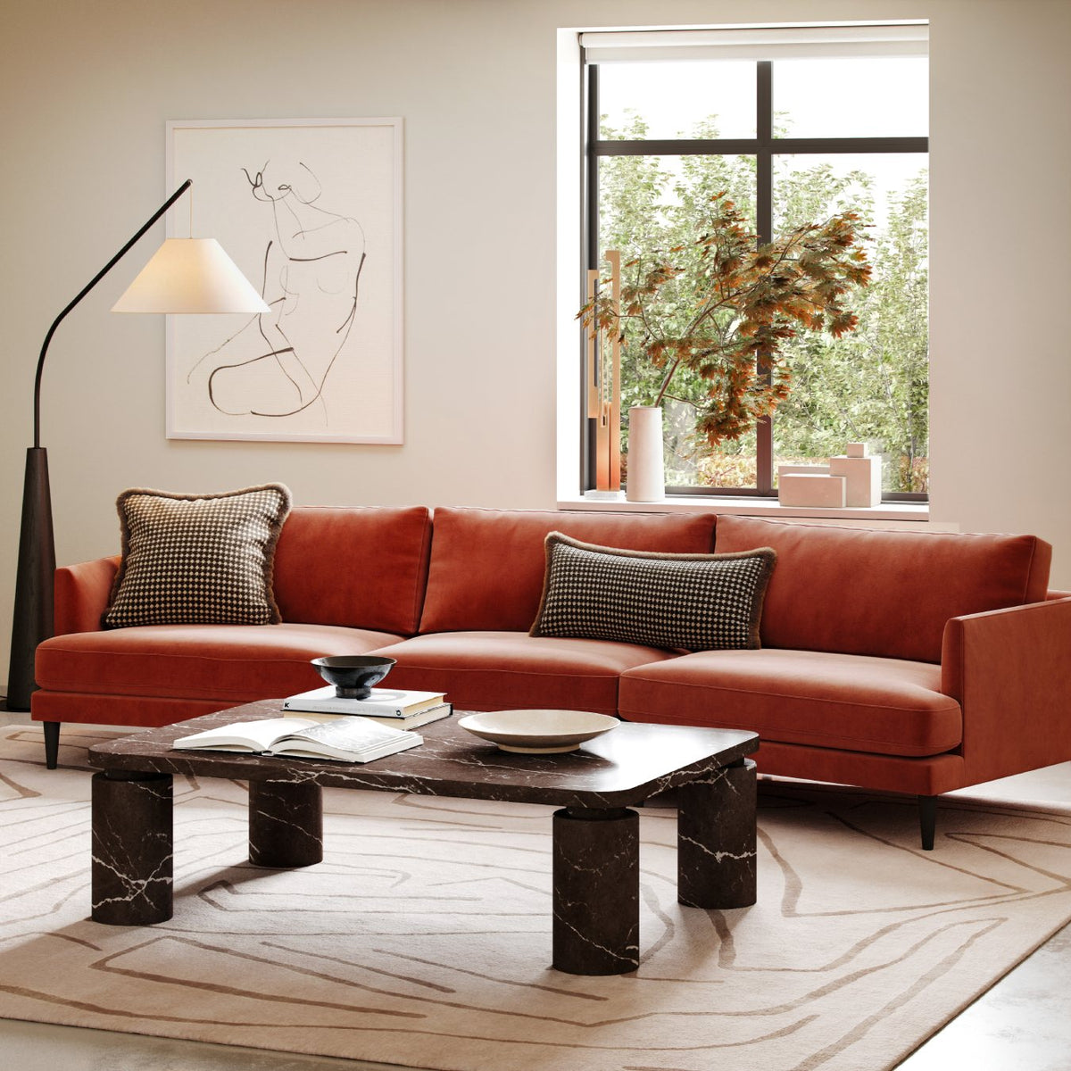 Modern living room with rust velvet sofa, black marble coffee table, minimalist art and floor lamp by window
