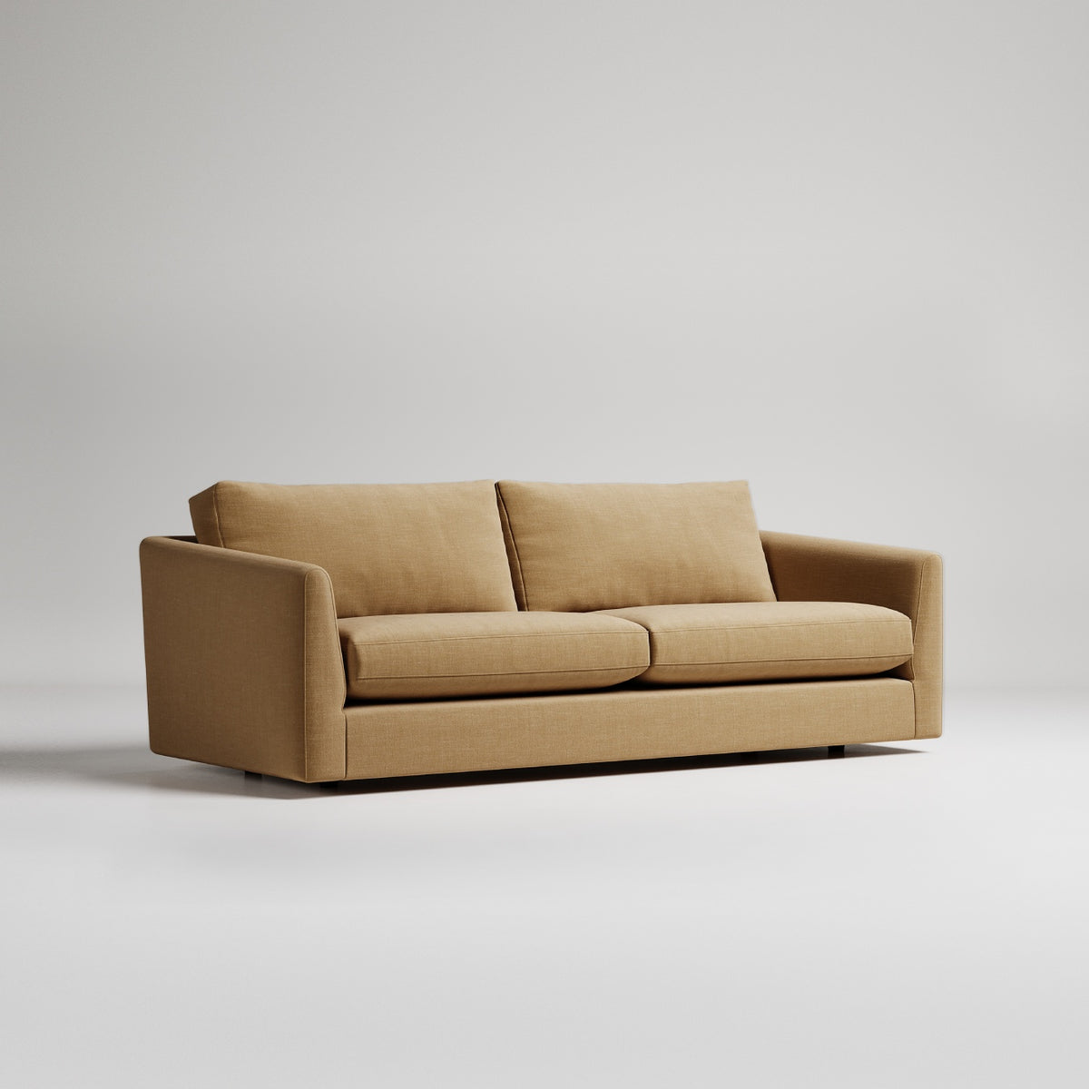 Modern tan fabric sofa with clean lines against light gray background, minimalist studio product shot
