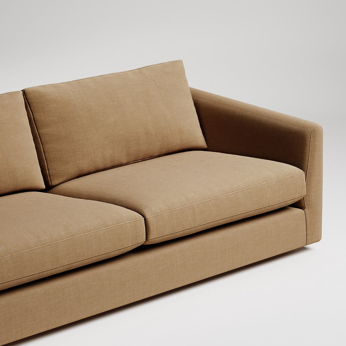 Modern tan velvet sofa with clean lines and plush cushions on white background
