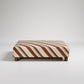 Patterned rectangular ottoman or coffee table with clean lines against white background
