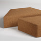 Cork yoga blocks in geometric angular design on white background, minimalist wellness equipment

