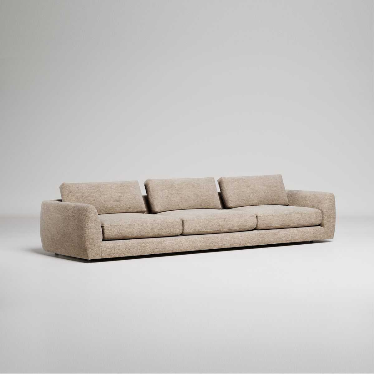 Modern beige upholstered sofa with curved arms and back on grey background