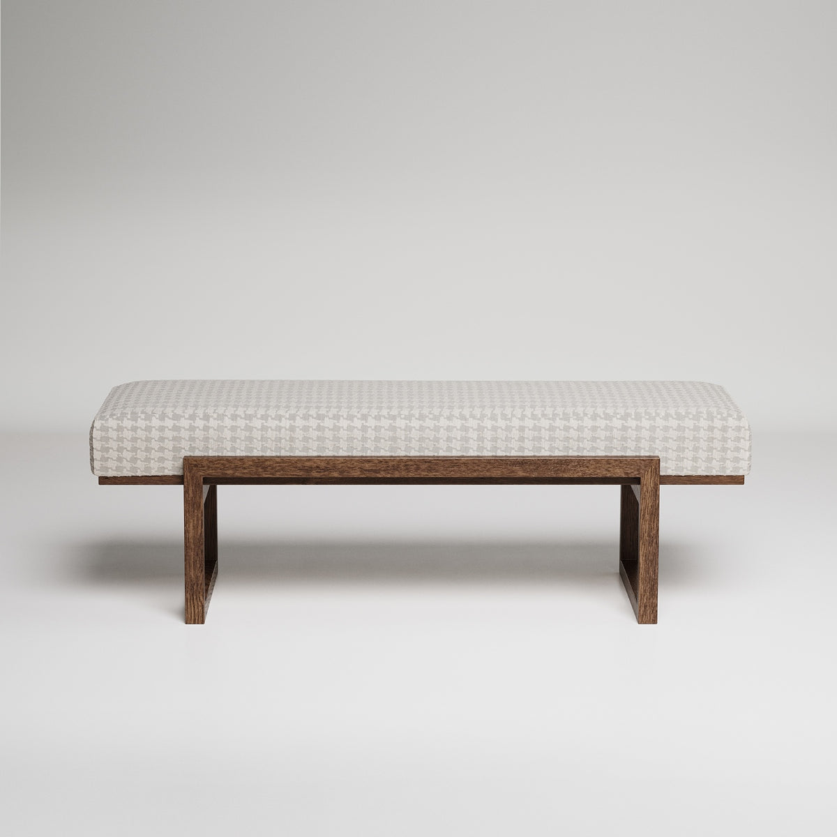 Modern upholstered bench with white houndstooth fabric cushion on minimalist dark wood frame against grey background
