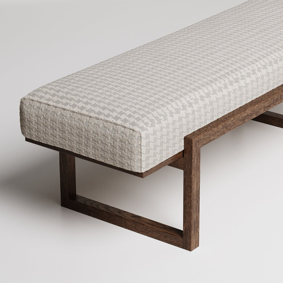 Modern upholstered bench with textured cream fabric and dark wooden geometric base against white background
