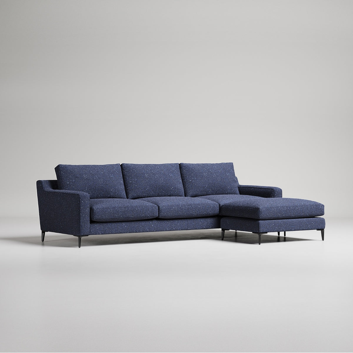 Modern navy blue L-shaped sectional sofa with chaise lounge on metal legs against light gray background
