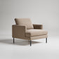 Modern beige textured armchair with black metal legs on light gray background, minimalist design
