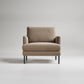Modern beige textured armchair with black metal legs on light gray background, studio product shot
