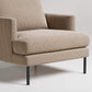 Modern armchair with textured beige upholstery and black metal legs, shown in close-up detail against white background
