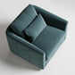 Modern teal velvet armchair with clean lines photographed from above on white background
