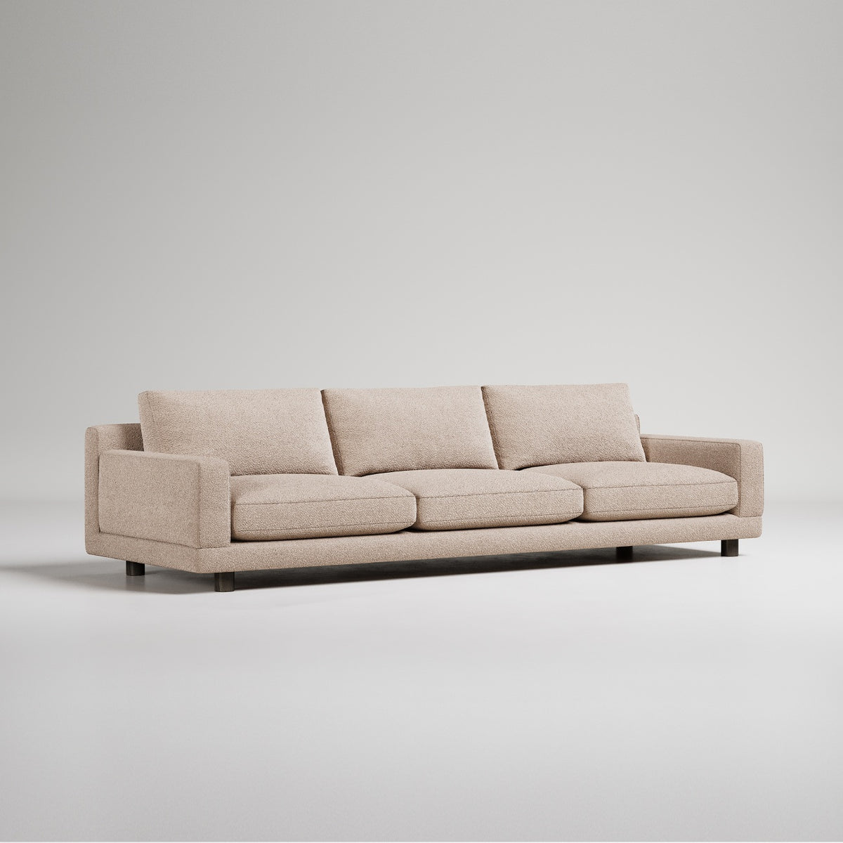 Modern beige three-seater sofa with clean lines and metal feet, photographed on white background
