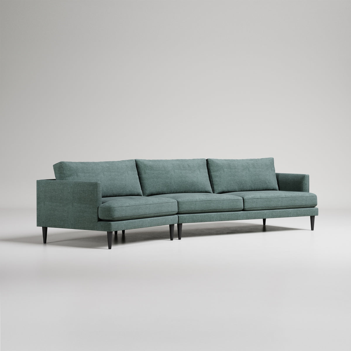 Modern sage green sectional sofa with clean lines, tapered legs, and loose back cushions on light gray background

