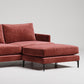 Modern terracotta velvet sectional sofa ottoman with black metal legs against white background
