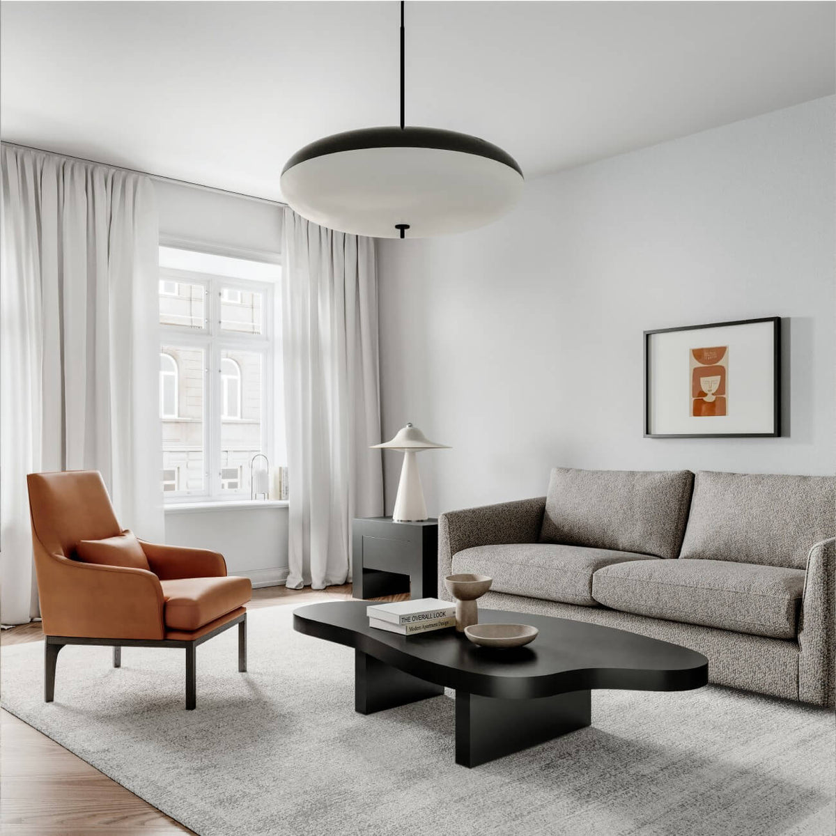 Modern minimalist living room with tan leather chair, gray sofa, black coffee table, and white curtains.
