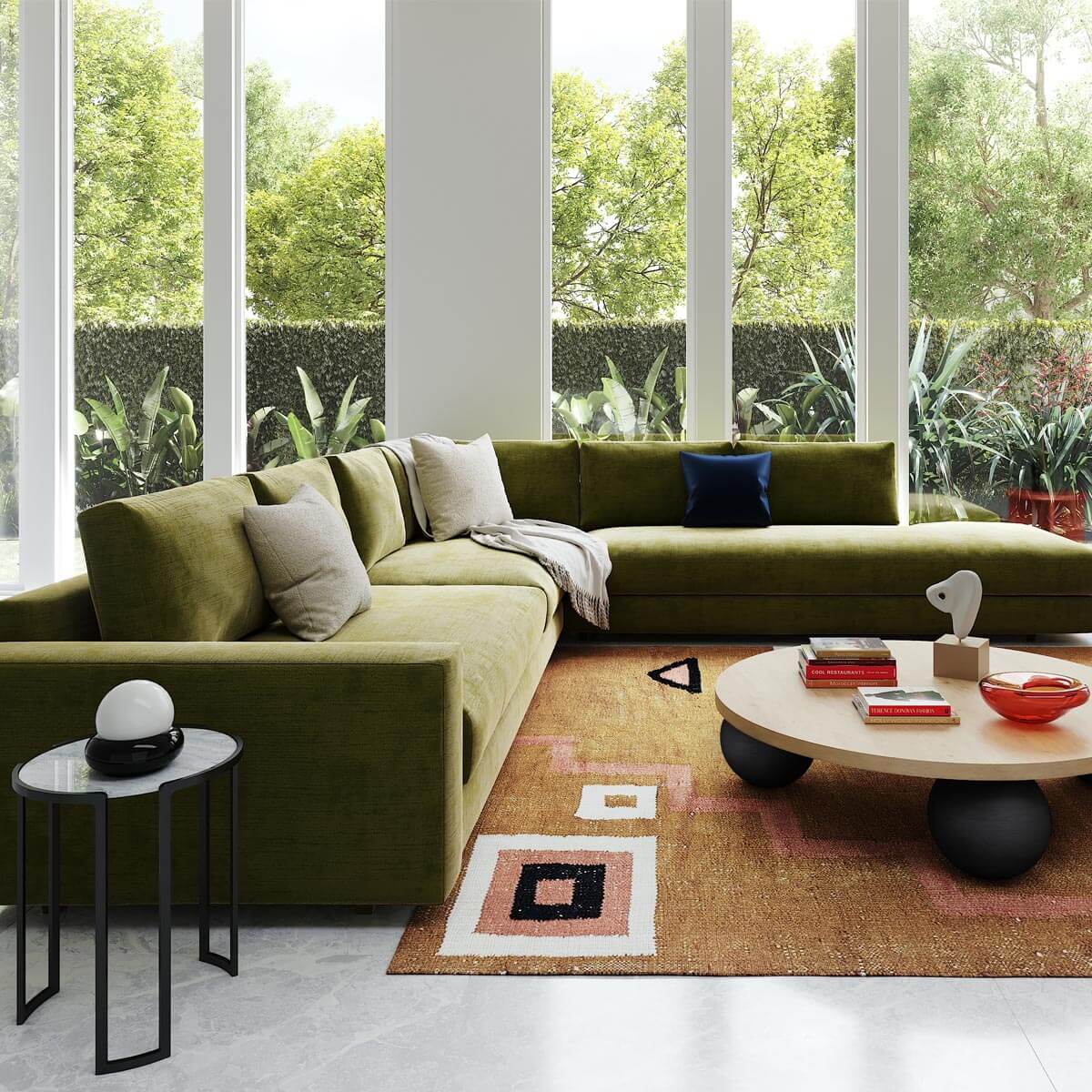 Modern living room with olive green sectional, geometric rug, floor-to-ceiling windows, and tropical garden view
