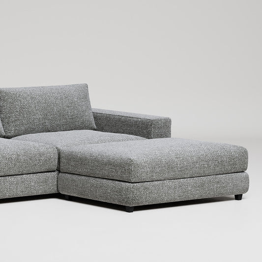 Modern gray L-shaped sectional sofa with chaise lounge on white background, clean minimalist furniture design
