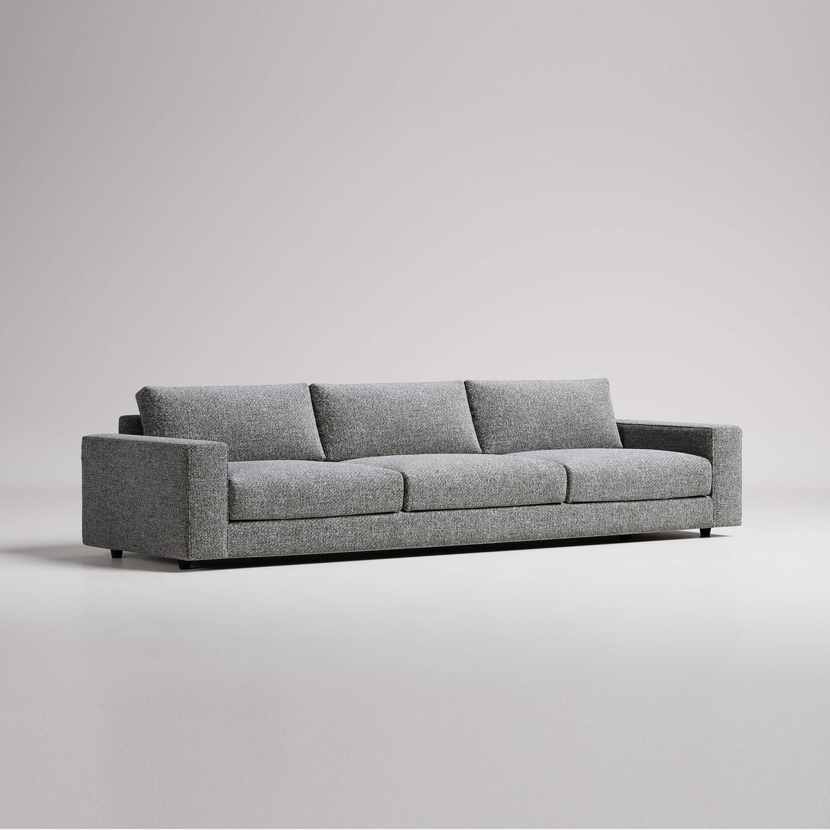 Modern grey three-seater sofa with clean lines against white background, studio product photography
