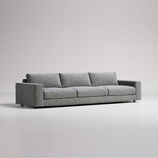 Modern grey three-seater sofa with clean lines against white background, studio product photography
