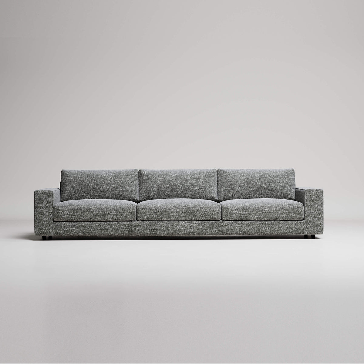 Modern gray 3-seater sofa with clean lines and textured upholstery against neutral background
