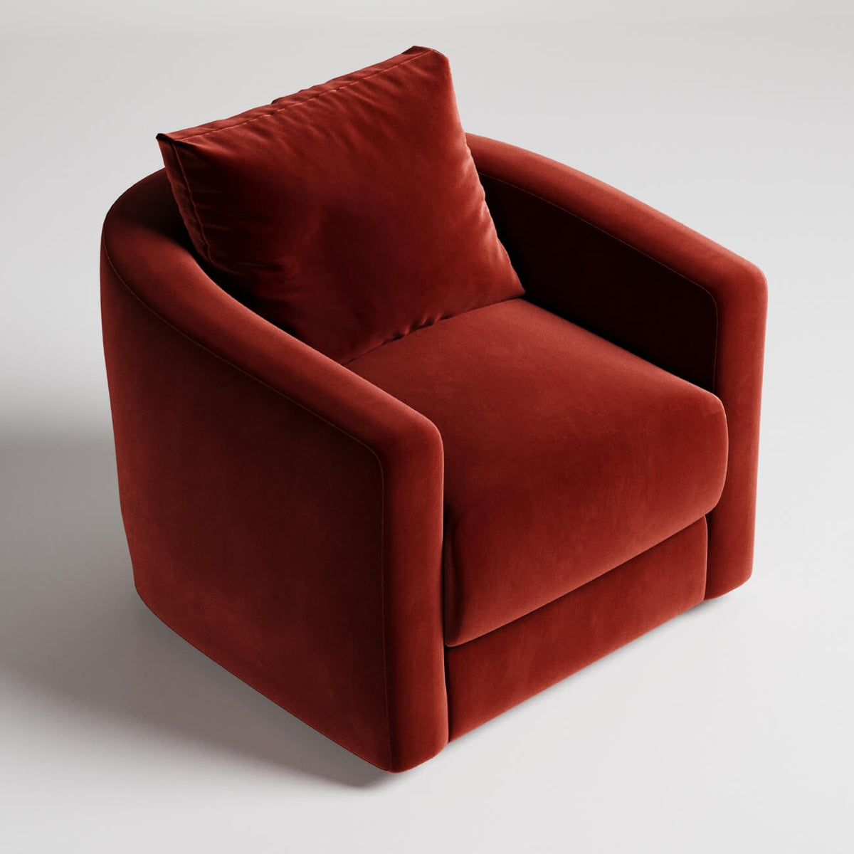 Modern rust-colored velvet armchair with clean lines and matching throw pillow against white background
