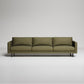 Modern olive green 3-seater sofa with slim metal legs against neutral gray background
