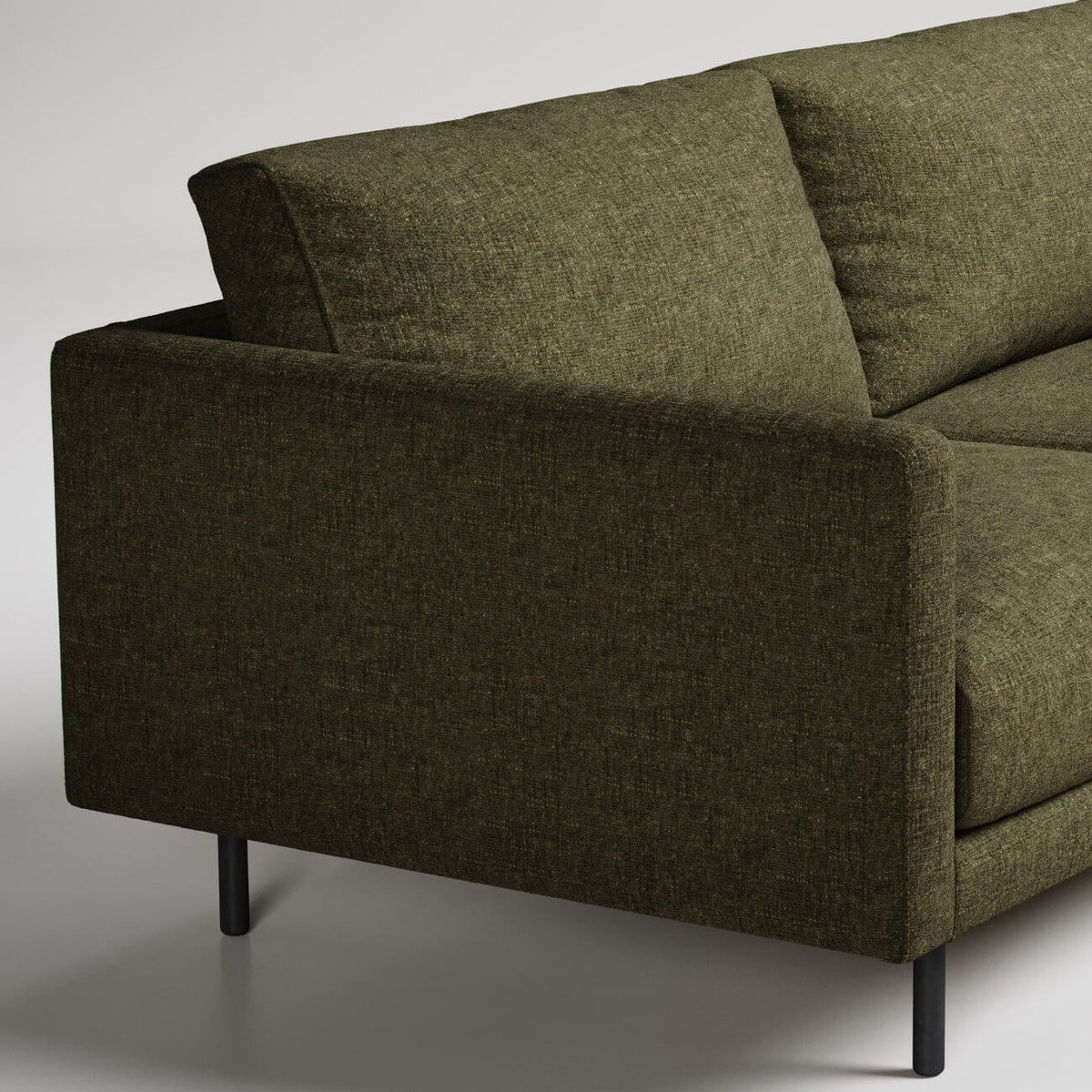 Modern olive green sofa with black metal legs, close-up detail shot showing textured upholstery fabric
