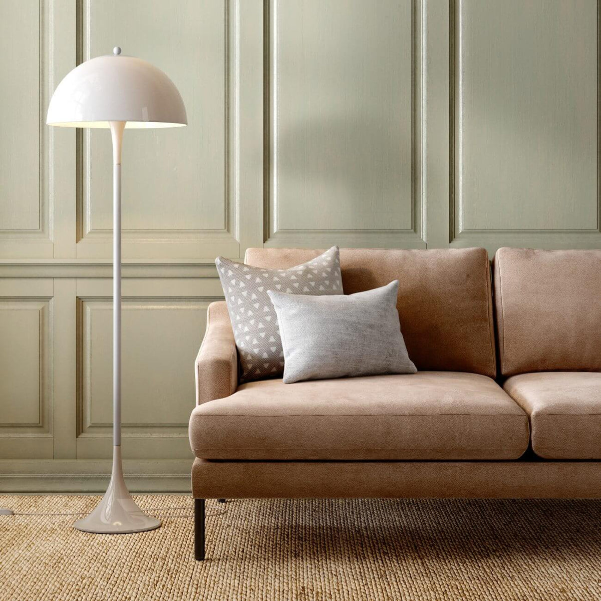 Modern living room with beige sofa, white floor lamp, sage green paneled walls and jute rug
