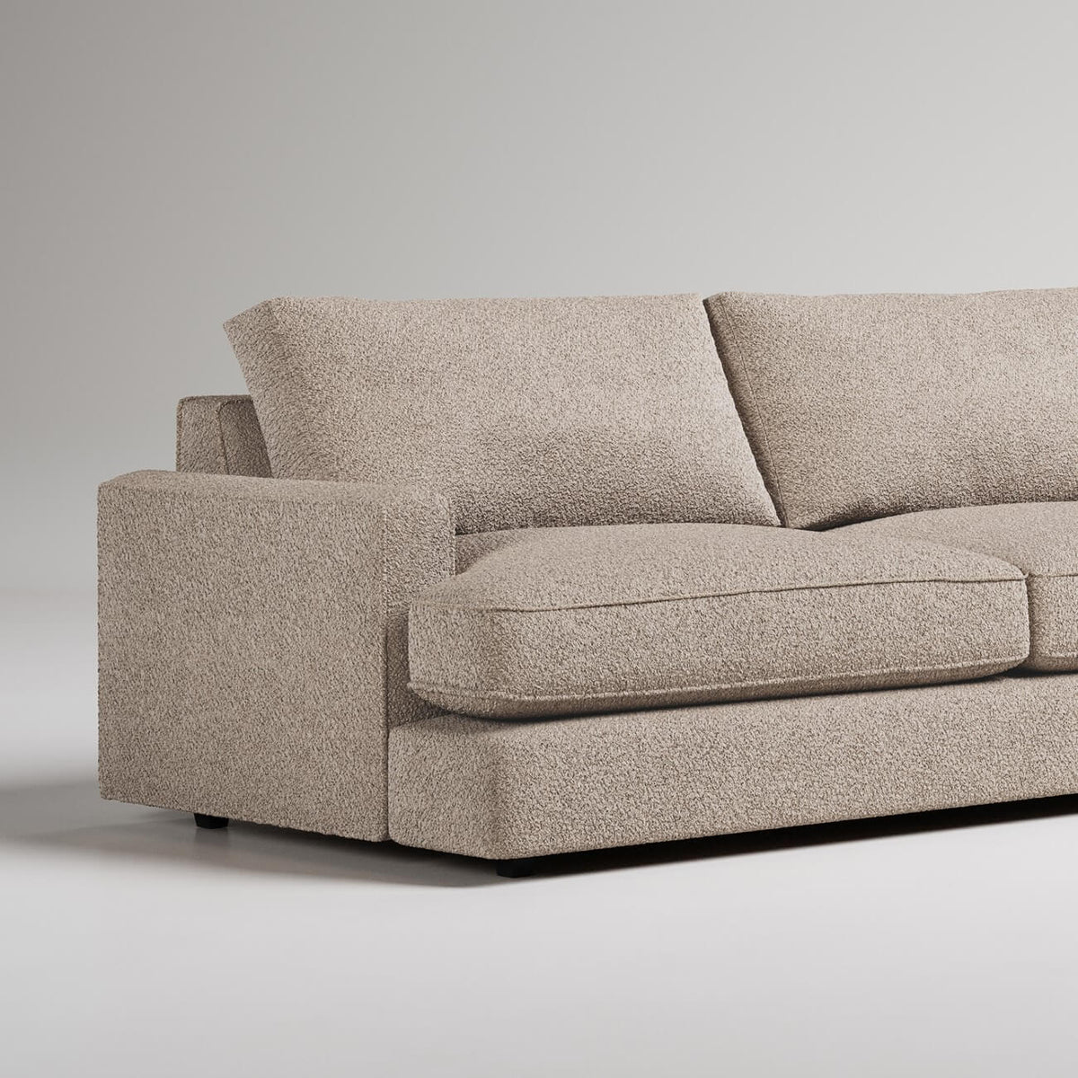 Modern beige boucle sofa with clean lines and squared arms against neutral background
