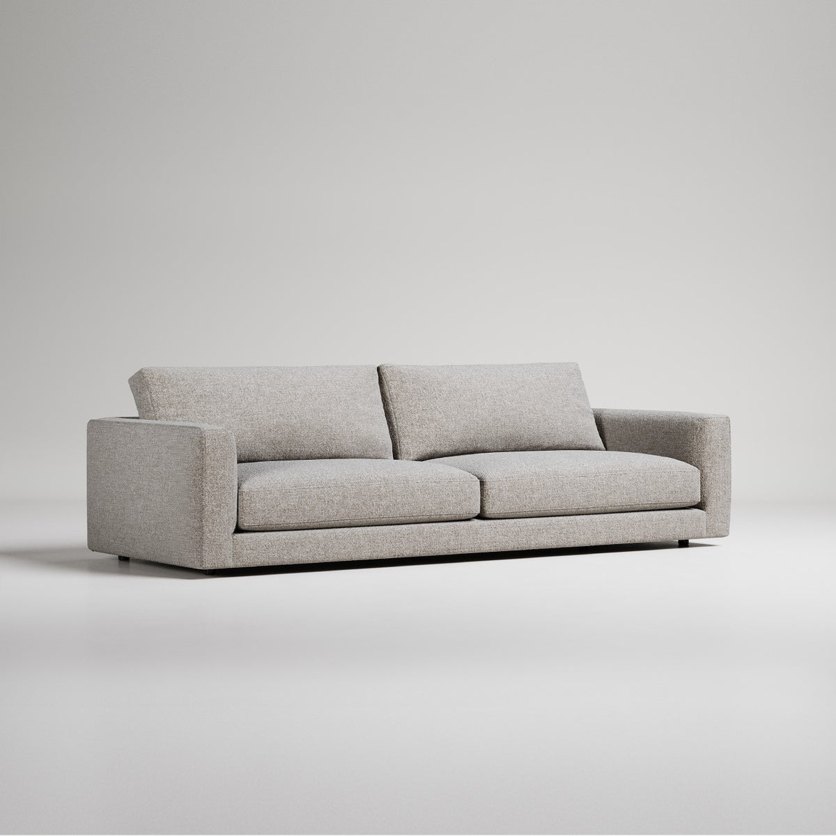 Modern gray fabric sofa with clean lines and low profile against white background
