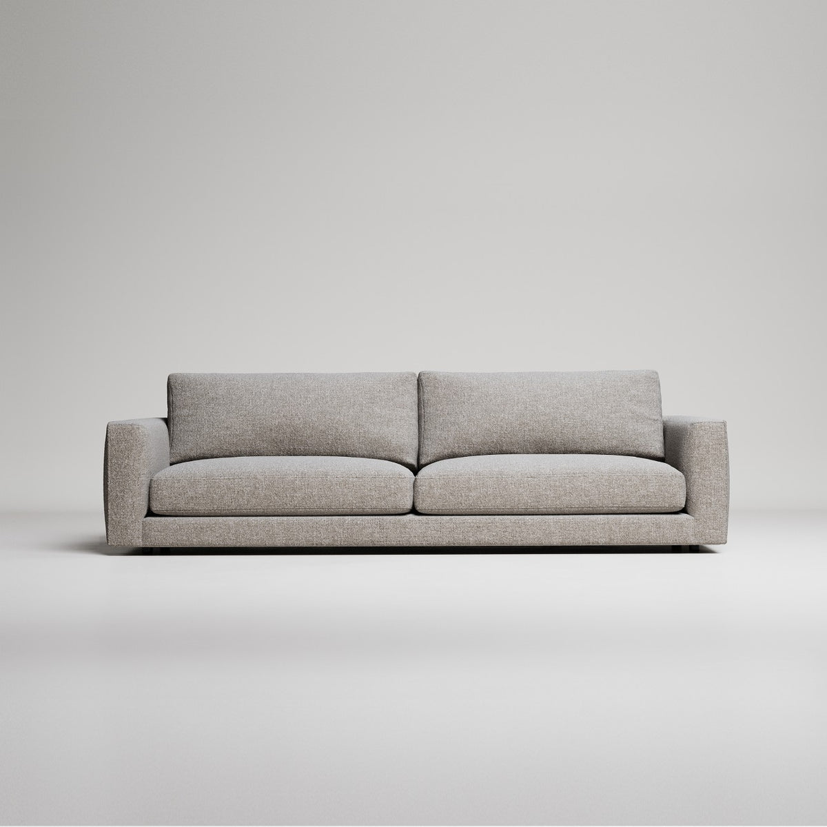 Modern grey fabric sofa with clean lines against white background, minimalist studio product photography
