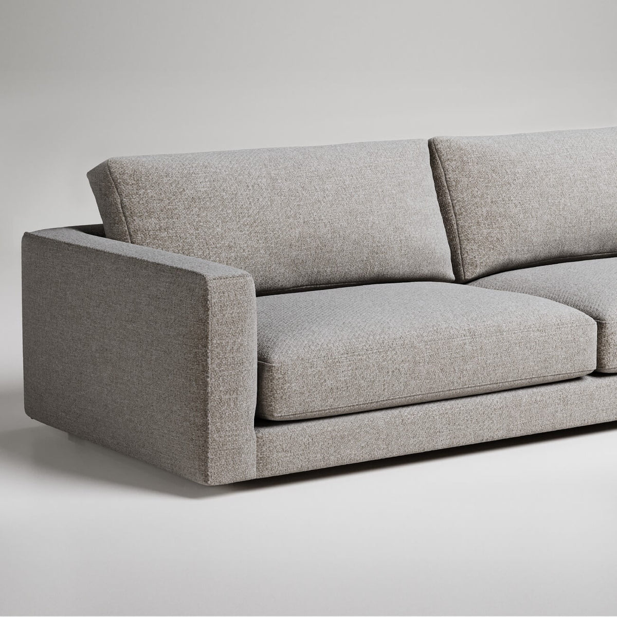 Modern gray sofa with clean lines and textured upholstery shown against white background, partial view

