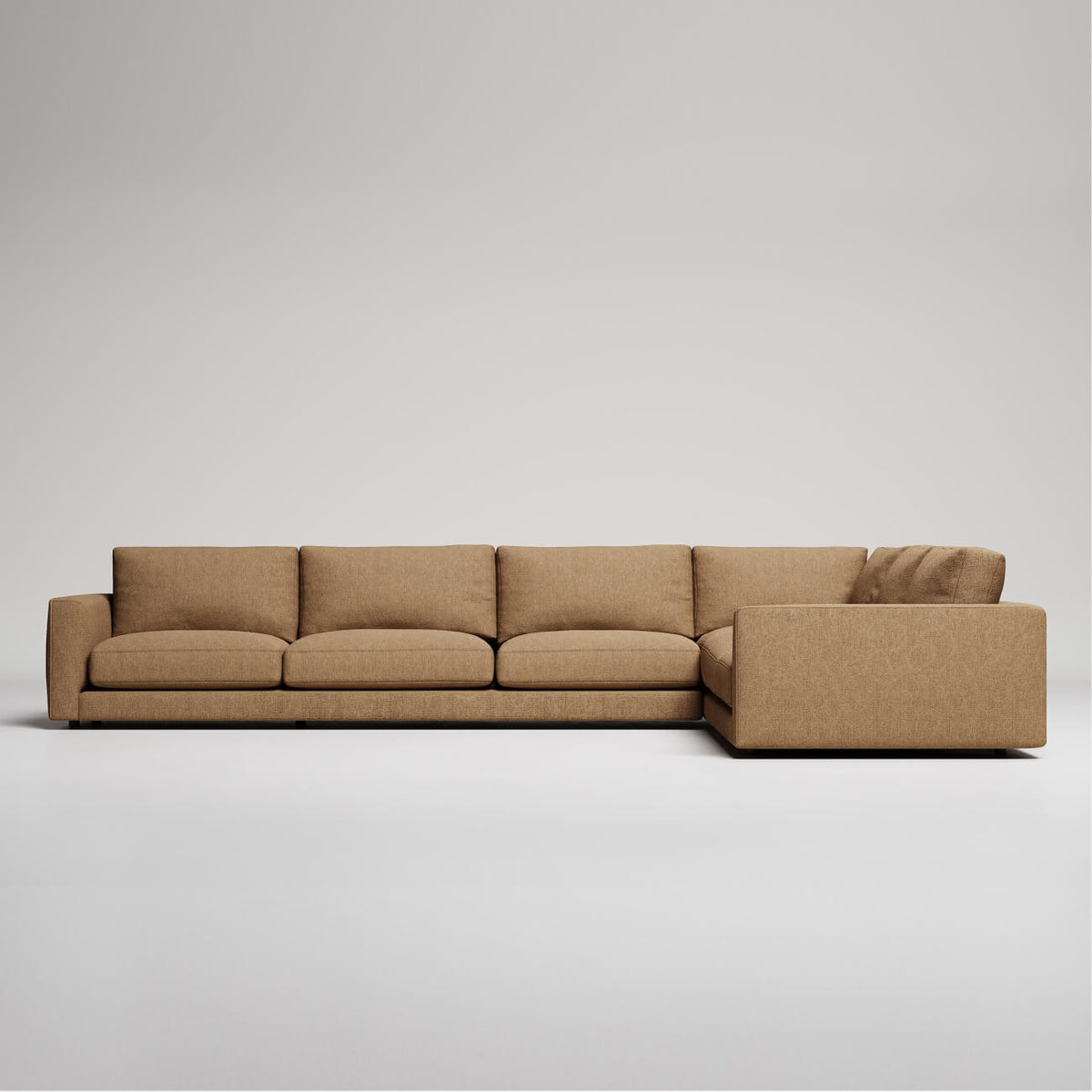 Modern L-shaped sectional sofa in tan fabric with clean lines and rectangular design against light background
