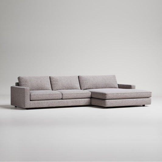 Modern grey L-shaped sectional sofa with chaise lounge on white background, minimalist furniture design
